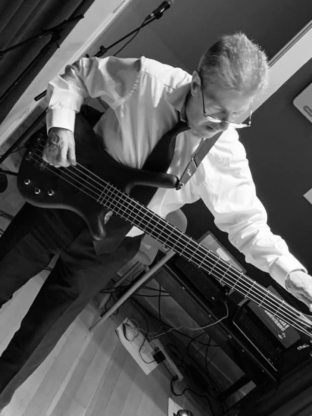 Stephen Travers playing the bass guitar