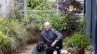  Mark Grehan and his French bulldog, Finn,  in his garden at his apartment in Cork Street, Dublin. Photograph: Tom Honan 