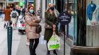 People queue outside shops wearing protective face masks as a precaution against the transmission of the novel coronavirus in Dublin on Wednesday. Photograph: Paul Faith/AFP