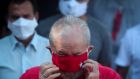  Former president of Brazil Lula adjusts his facial mask while talking to the press after voting in São Bernardo do Campo, Brazil, on November 15th. Photograph: Fernando Bizerra/EPA