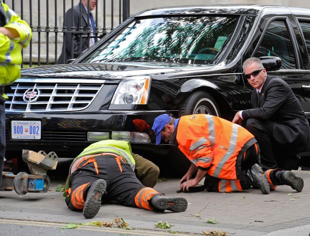 Trapped beast: mechanics try to free the presidential limo after it got stuck on the crest of a ramp at the US embassy in Dublin in 2011. Photograph: Dave Meehan