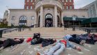Protesters staging a die-in outside the courthouse, where a Purdue Pharmaceuticals bankruptcy hearing was  being held. Photograph:  Erik McGregor/ LightRocket via Getty 