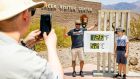 Temperature tourism: People pose for photos at the Furnace Creek Visitors Center, Sunday, July 11th in Death Valley – and the temperature continued to rise. Photograph: Roger Kisby/The New York Times