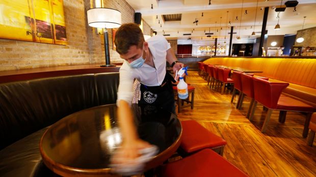 A staff member in the Dakota bar in Dublin preparing for indoor dining. Photograph: Alan Betson