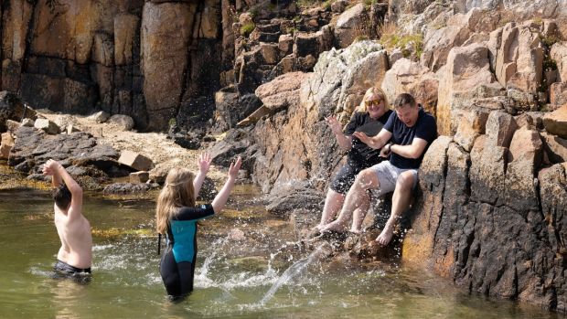 Crona with her husband Phil Carney and two children, Kate and Harry in the sea near their holiday home in Dungloe Co. Donegal. Photograph: Joe Dunne