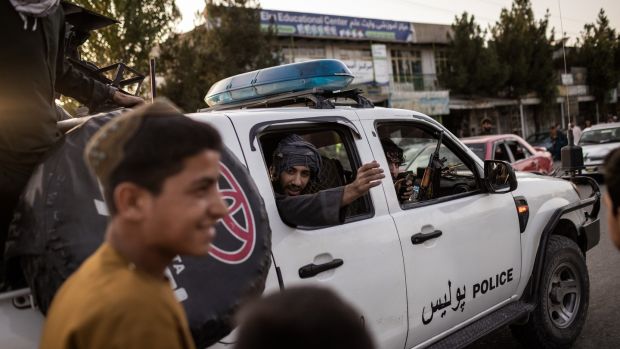 Taliban fighters drive into Kabul. Photograph: Jim Huylebroek/The New York Times