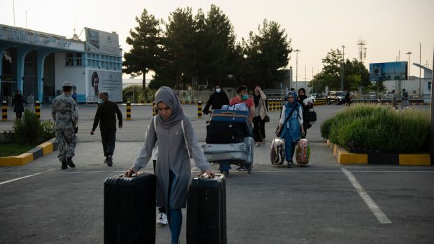 People pass through checkpoints at the Hamid Karzai International Airport in Kabul ahead of the Talibanâ€™s arrival, where one resident described seeing women crying by the side of the road, desperately trying to get a ride home and to barricade their doors. Photograph: Jim Huylebroek/The New York Times