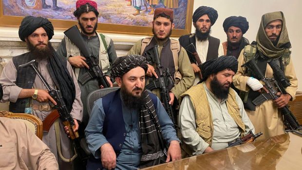 Taliban fighters in the presidential palce in Kabul on Sunday night. Photograph: Zabi Karimi/AP