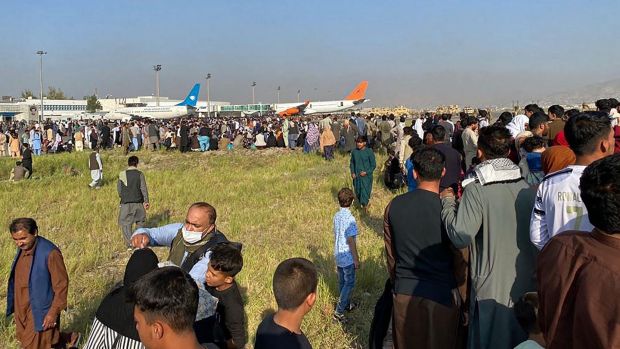 Afghans crowd at Kabul airport. Photograph: Shakib Rahmani/AFP via Getty Images