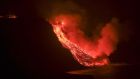 Lava flow from the Cumbre Vieja volcanic eruption in La Palma reaching the sea in an area of cliffs next to Tazacortes coast, Canary Islands, on Tuesday night. Photograph: EPA