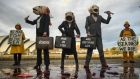 Activists wearing fish heads during an Ocean Rebellion demonstration on Thursday in Glasgow. Photograph: Peter Summers/Getty Images