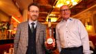 Frank Bouchier-Hayes presents Billy Dempsey, owner of Davy Byrnes pub, with a bottle of Giffard’s Orange Curaçao-Liqueur. Photograph: Dara Mac Dónaill 
