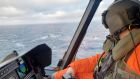 A helicopter pilot involved in rescue and recovery efforts off Newfoundland, Canada,  following the sinking of the Spanish fishing vessel Villa de Pitanxo. Photograph:  EPA/Canadian armed forces 