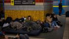 People sleep in the Kyiv subway, using it as a bomb shelter on Friday. In Ukraine’s capital, many residents hurried underground for safety overnight Thursday and Friday as Russian forces fired on the city and moved closer. Photograph: Emilio Morenatti/AP