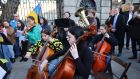 Students from the Royal Irish Academy of Music play the Ukrainian national anthem outside Leinster House. Photograph: Dara Mac Dónaill