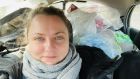 Lyudmyla Yankina behind the wheel of a car filled with aid supplies for Vulnerable people in Kyiv. Photograph: Lyudmyla Yankina