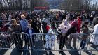 Ukrainian people wait in line to apply for their Polish personal identification number  at the national stadium in Warsaw. Photograph: Czarek Sokolowski/AP