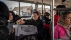 Ukrainian refugees sit on a shuttle bus after crossing the Ukrainian border with Poland at the Medyka border crossing, southeastern Poland. Around 90 percent of them are women and children. Photograph: Angelos Tzortzinis/AFP/Getty Images