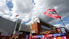 Fans arrive at Anfield ahead of Sunday’s derby match between Liverpool and Everton. Photograph: Clive Brunskill/Getty Images