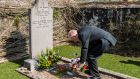 Greg Alexander, Methodist Minister, lays a wreath on the grave of 82-year-old victim James Buttimer marking  100th Anniversary of the Bandon Valley killings. Photograph: Andy Gibson