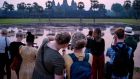 Tourists  watch the sun rise over the Angkor Wat temple complex in Cambodia: Tourism creates value, enriches cultural exchange,  expands minds and  spreads wealth from richer parts of the world to developing regions. Photograph:  Tang Chhin Sothy/AFP via Getty Images