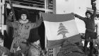 Palestinian fighters unfurl a Lebanese flag seized in the Holiday Inn hotel on March 24th, 1976. File photograph: Getty