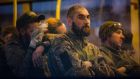 Ukrainian servicemen sitting in a bus after their surrender to Russian forces and evacuation from the besieged Azovstal steel plant in Mariupol on May 17th. Photograph: Alessandro Guerra/EPA 