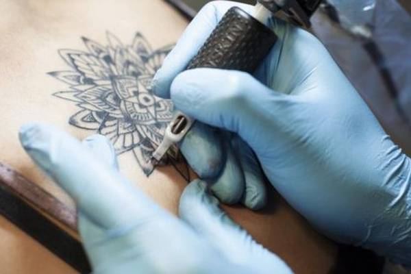 Tattoo parlours investigated over suspected spread of disease