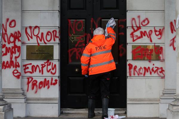 Man and woman charged after Government building covered in red graffiti