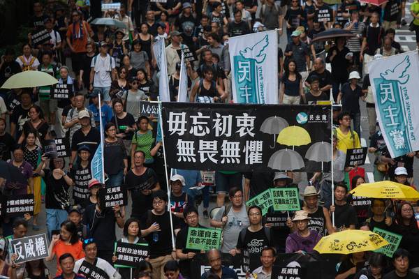 Hong Kong leader calls for unity after thousands join protests
