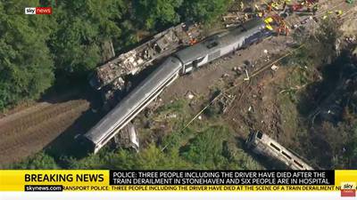 Three dead after train derails in floods-hit area of Scotland