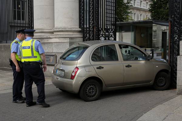 Woman who drove into gates of Government Buildings released