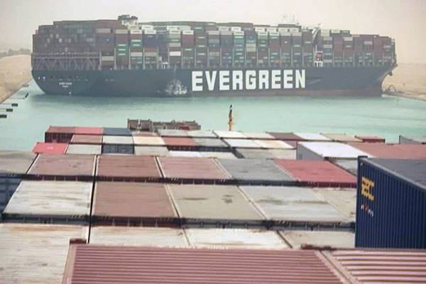 Ten tug boats try to free huge container ship blocking Suez Canal