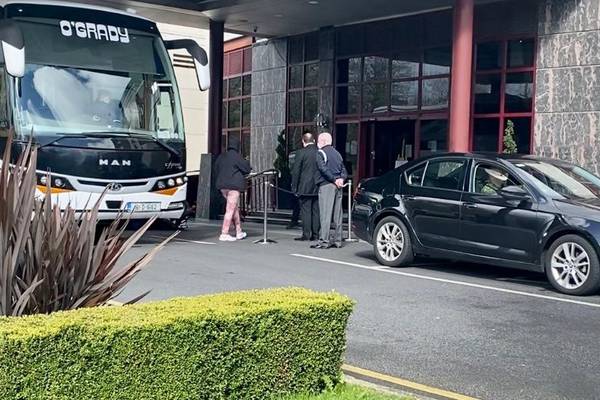 Woman escorted into mandatory quarantine hotel after refusing to leave bus