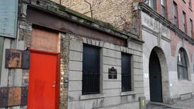 Masonry collapses into street from above  homeless hostel door