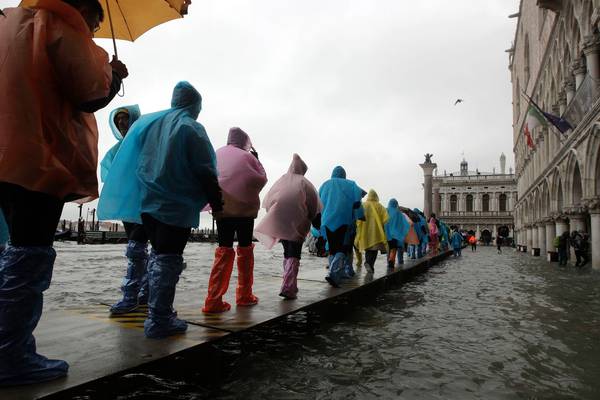 Cafes and stores in Venice hit by flooding following high tide