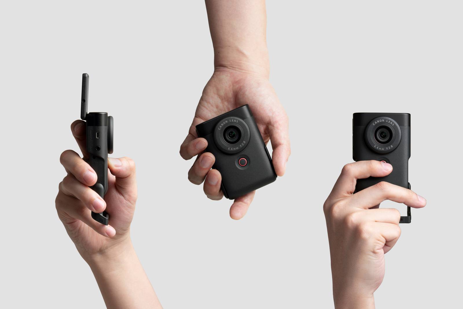 Compact camera held in one hand to demonstrate its size.