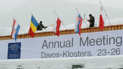 Business Week: Leaders to gather in Davos; Netflix and Intel report results