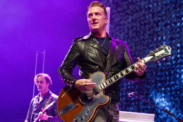 Josh Homme of Queens of the Stone Age kicks female photographer in head