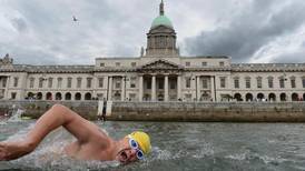 Speedos, yellow hats and little else as  Liffey swimmers dive in