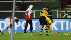 Borussia Dortmund fans throw dozens of tennis balls on pitch in ticket-price row