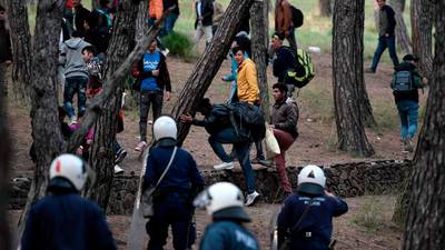 Greek and Turkish police fire tear gas as migrant border crisis deepens