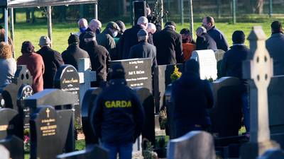 Uniformed gardaí watch as former Real IRA leader Michael McKevitt is buried in Louth