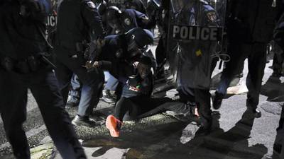 Twelve held in Baltimore after protest over black man’s death