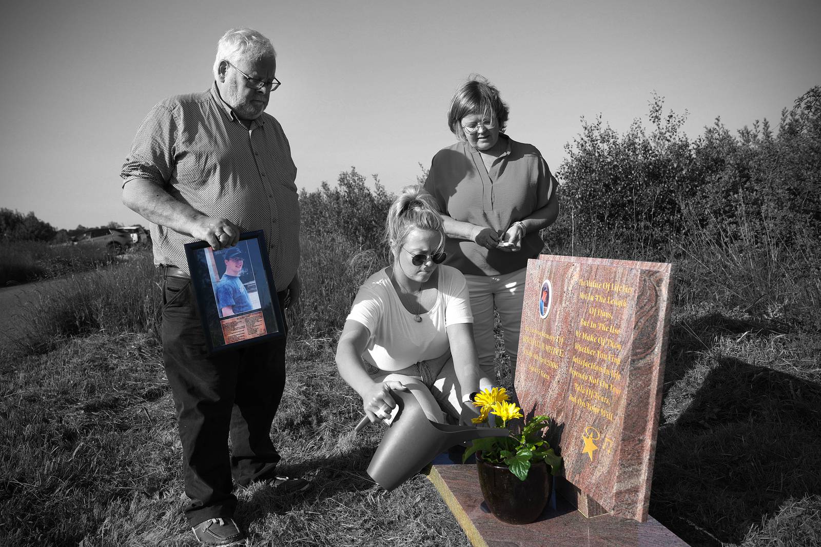 01/06/2023. NEWS The family of Michael White Jr, father Michael, mother Martina and sister Ciara tend to his roadside memorial in Clara, Co Offaly, where he was killed in a bus crash. Photograph : Laura Hutton / The Irish Times