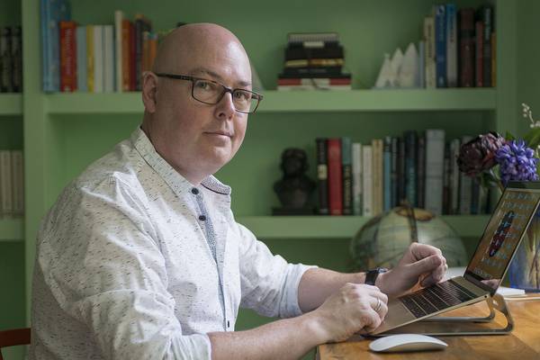 John Boyne flying flag for trans people even if he is holding it upside down