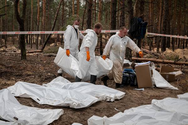 Ukrainian authorities exhume bodies at mass grave in Izium