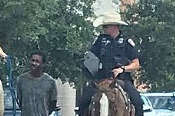 Texas: White police officers on horseback lead black man by rope