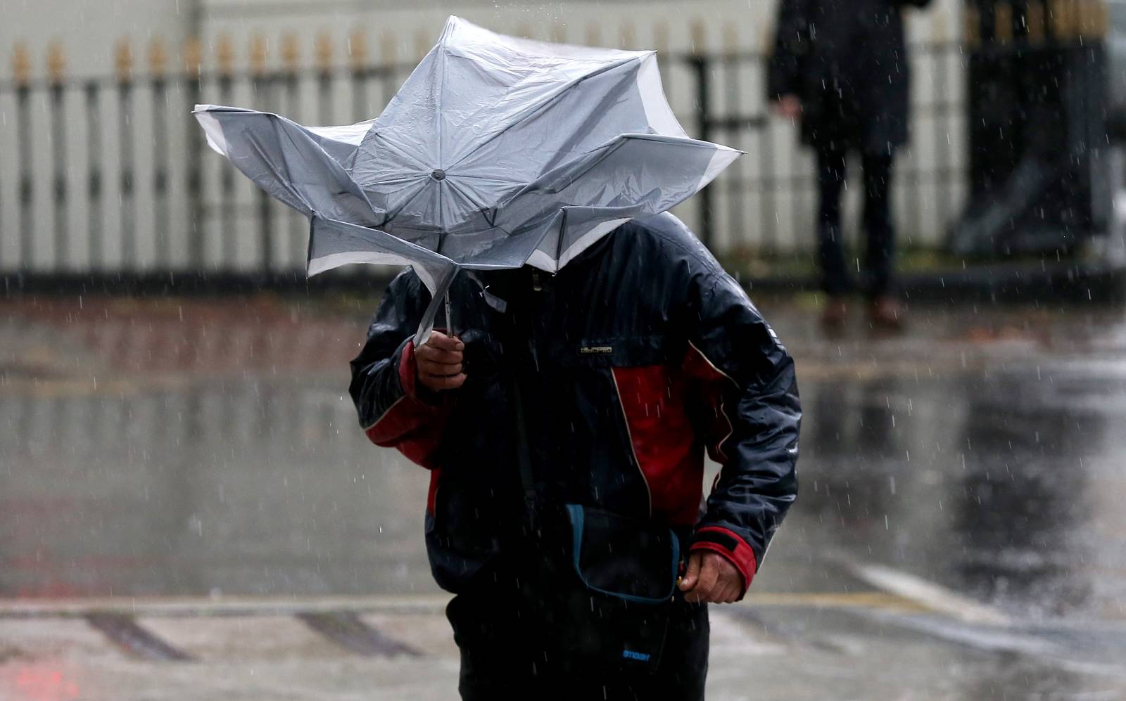 27/11/2018. A man struggles with a broken umbrella during a downpour in Dublin. Photo: Laura Hutton/Collins Photo Agency