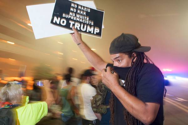 ‘We’re building that wall’: Protests at Trump’s Arizona rally